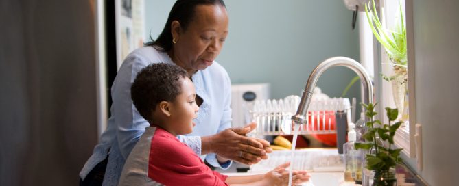 Boy mother washing hands